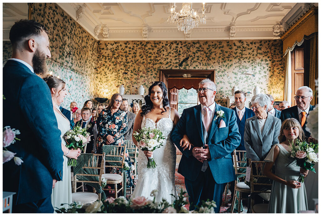 Bride walking into the Drawing Room at Sandon Hall